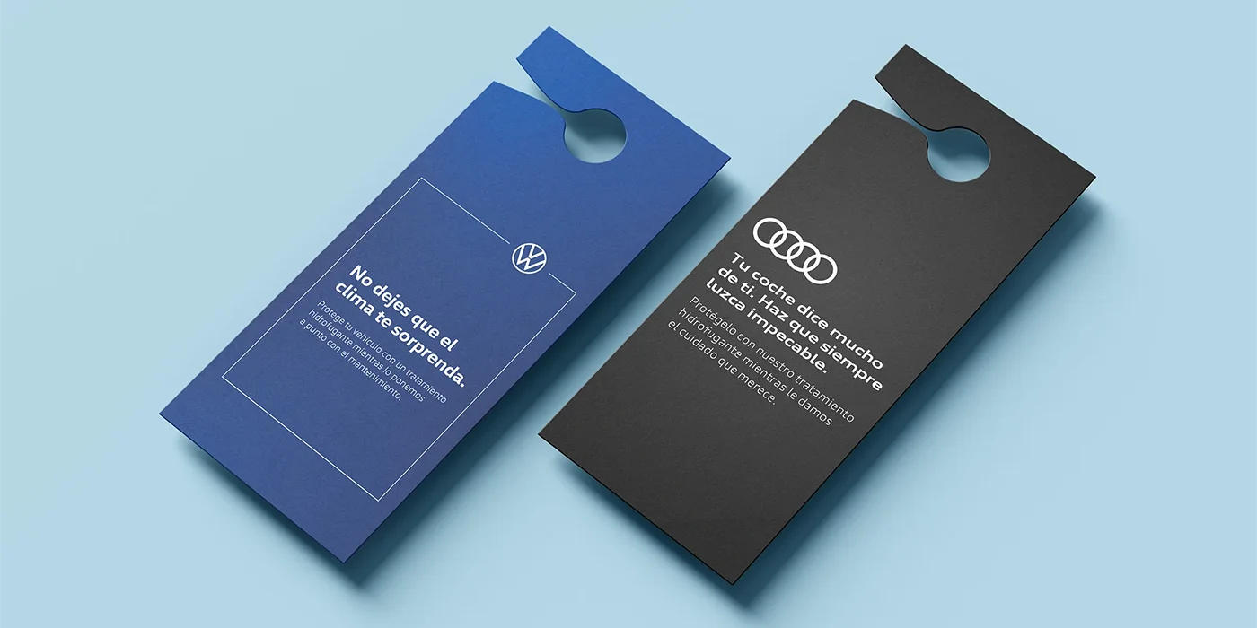 Graphic design mockup of printed rearview mirror hang tags for Audi and Volkswagen, promoting a water repellent windshield treatment to customers after car servicing.