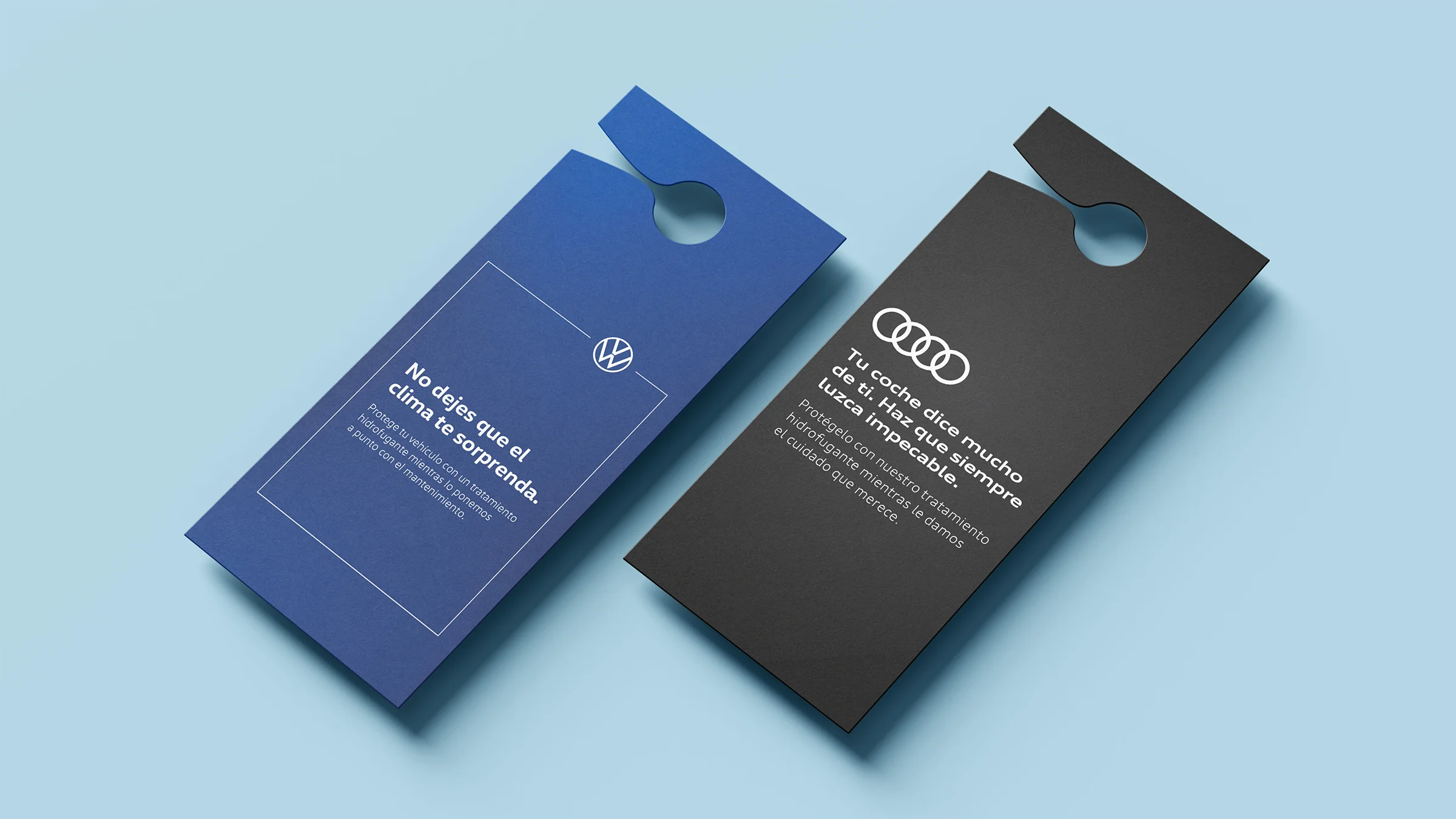 Graphic design mockup of printed rearview mirror hang tags for Audi and Volkswagen, promoting a water repellent windshield treatment to customers after car servicing.